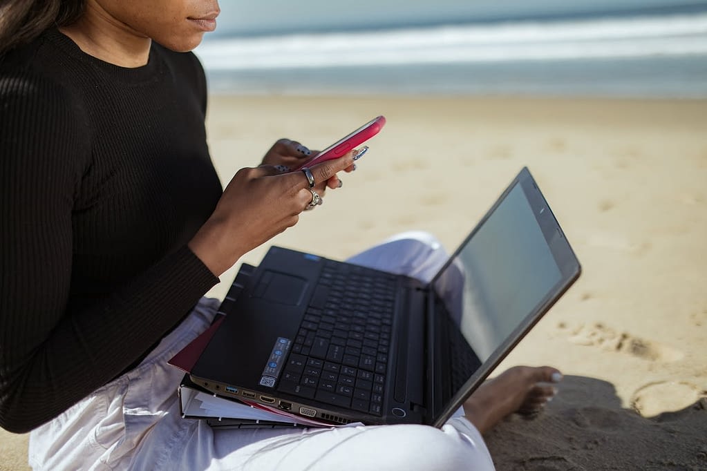 Digital Nomad Working on laptop on the beach